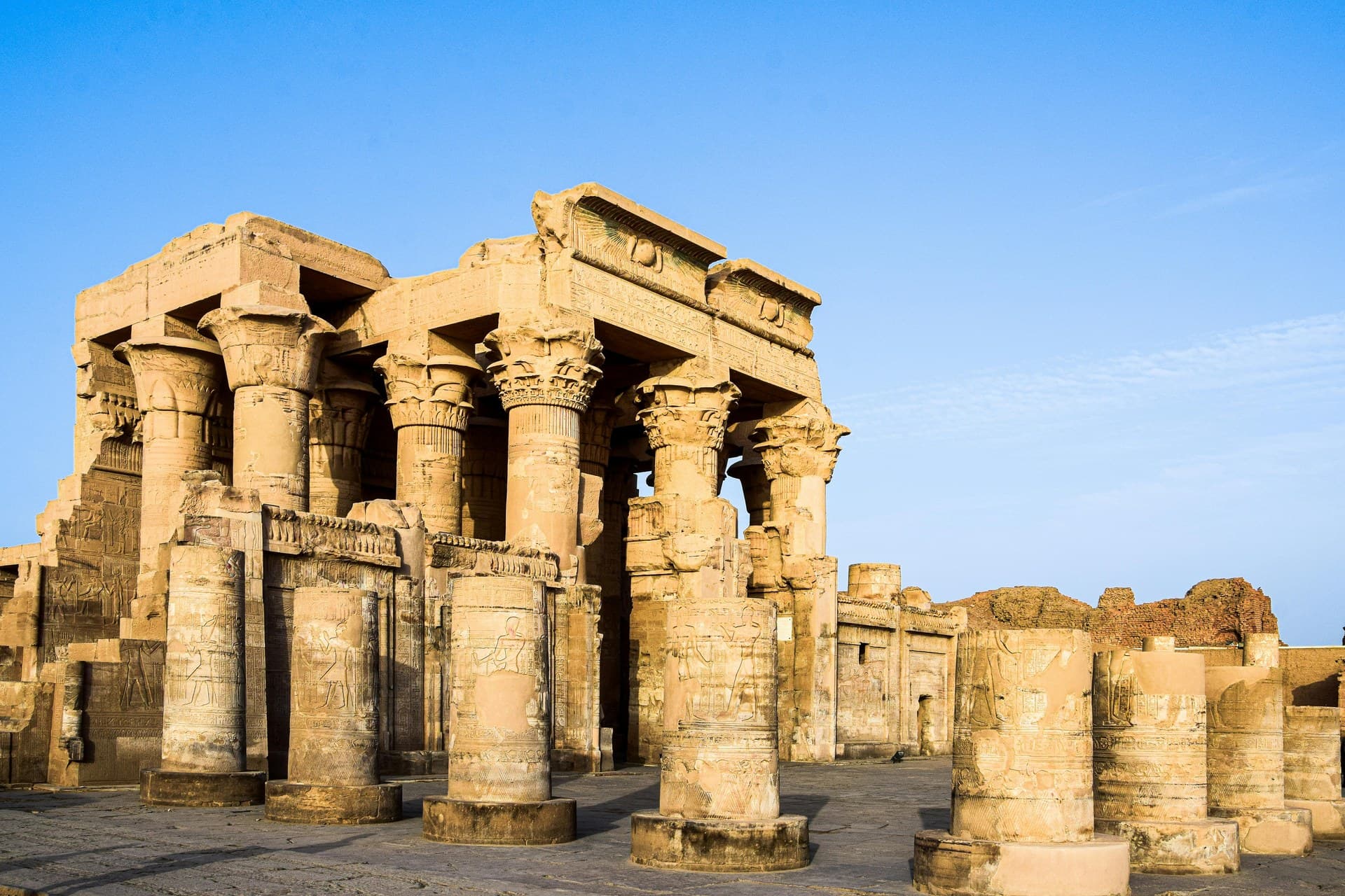The riverside columns of the double temple at Kom Ombo lit at dusk above the Nile