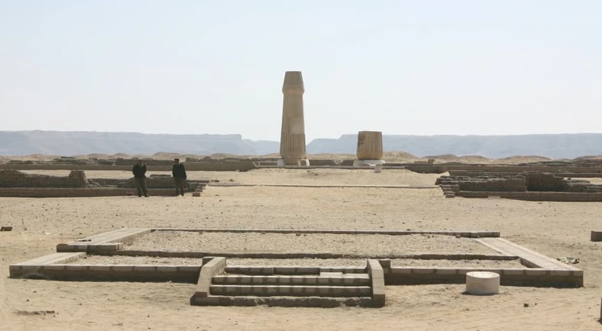 The marked-out foundations of the Small Aten Temple on the empty desert plain at Tell el-Amarna, with the cliffs behind