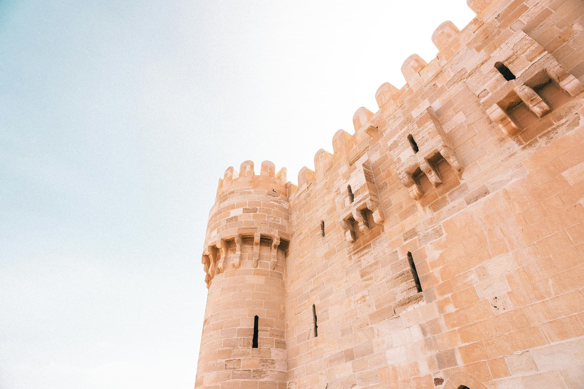 The pale stone walls of Qaitbay Citadel on its breakwater at the entrance to Alexandria's eastern harbour