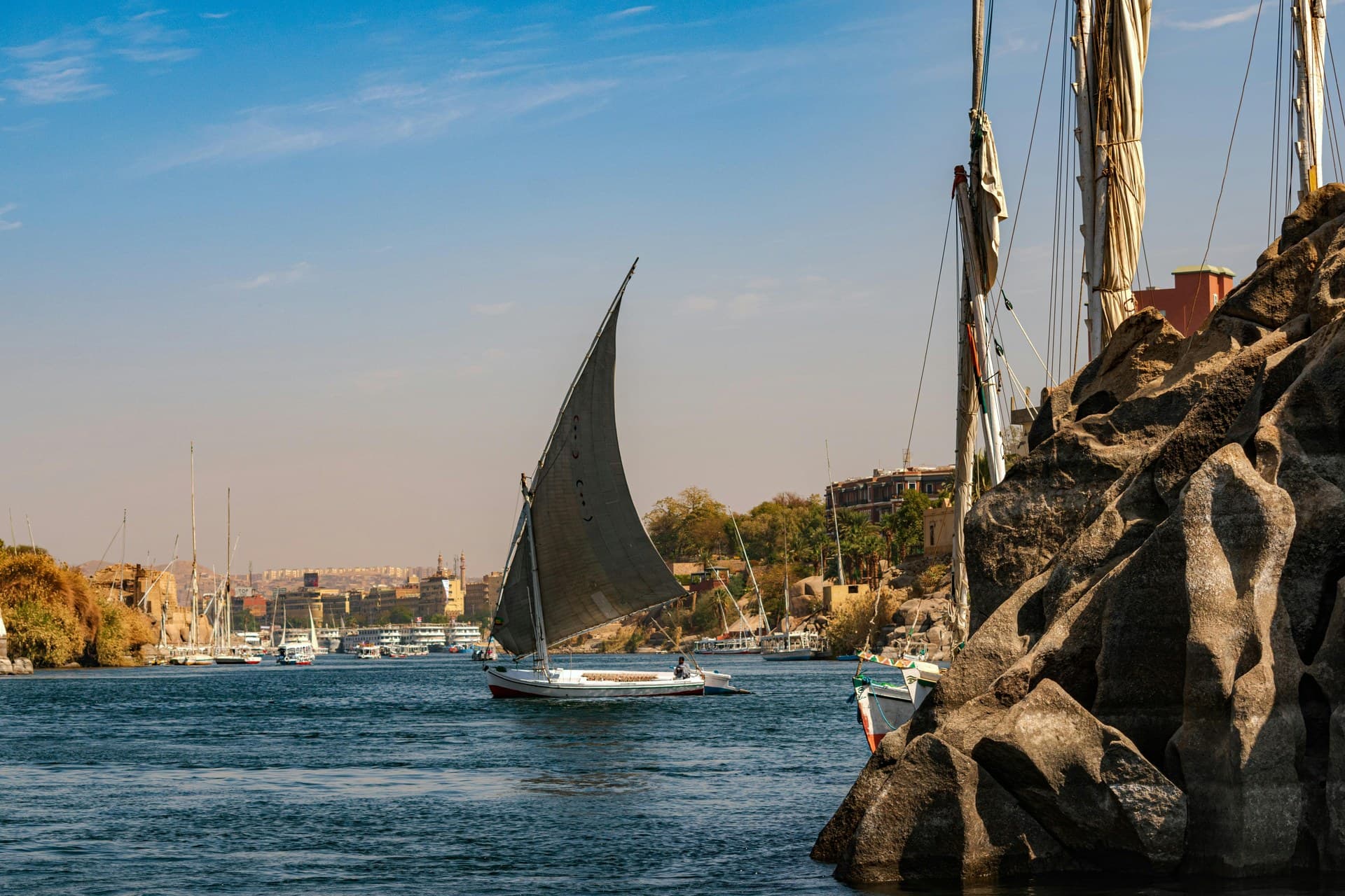 Sunset over the Nile with a felucca sail dark against the water