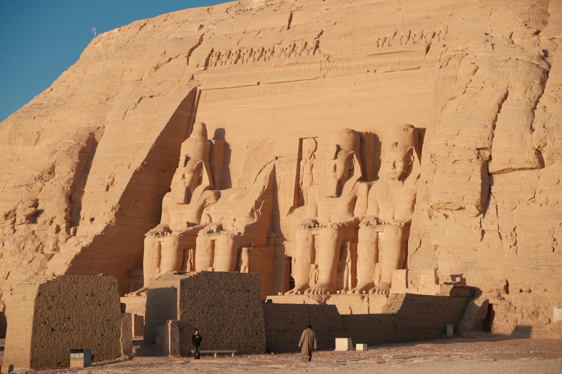The four seated colossi of Ramesses II cut into the rock face at the Great Temple of Abu Simbel