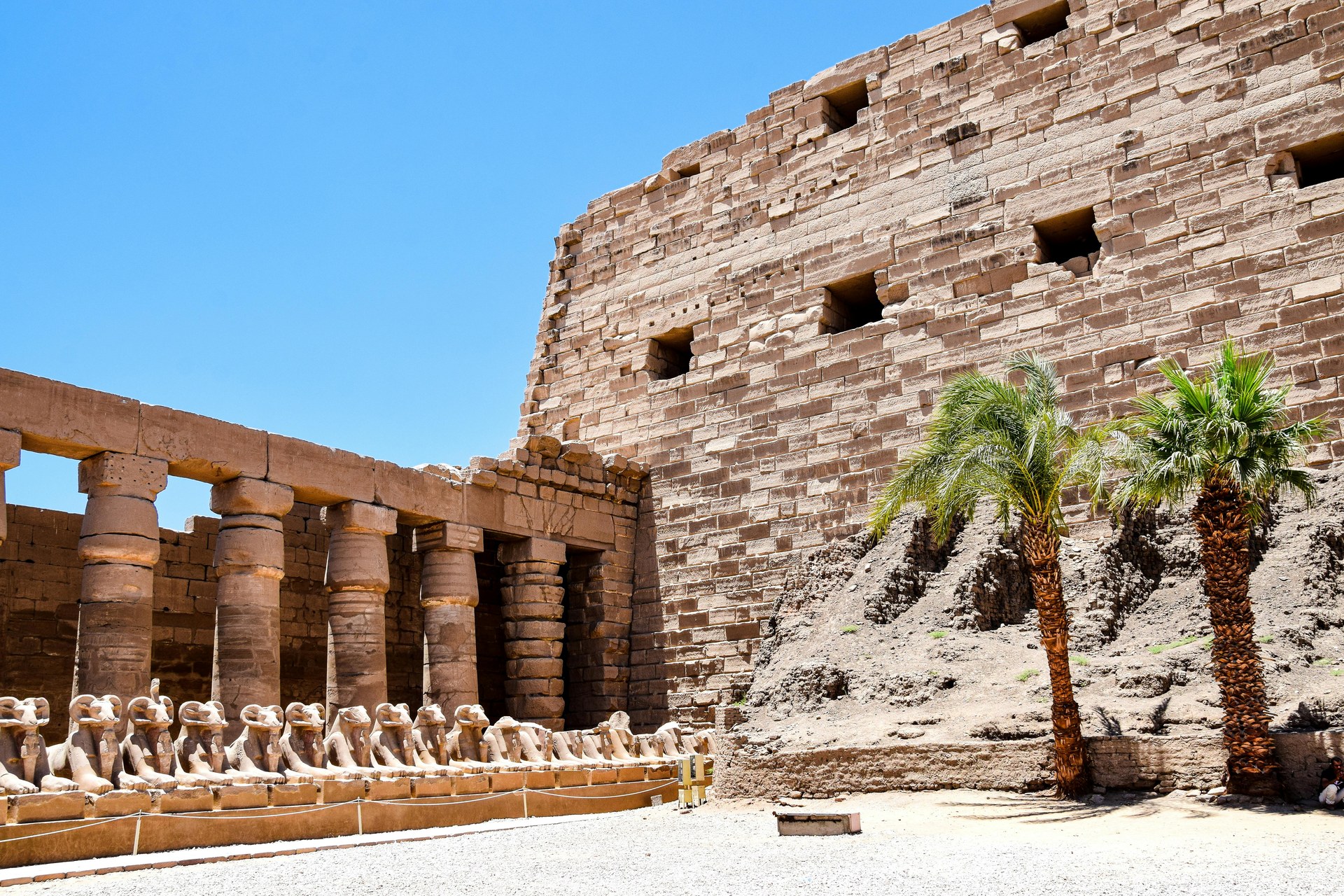 The massive sandstone columns of the Great Hypostyle Hall at Karnak, Luxor, lit by low sun