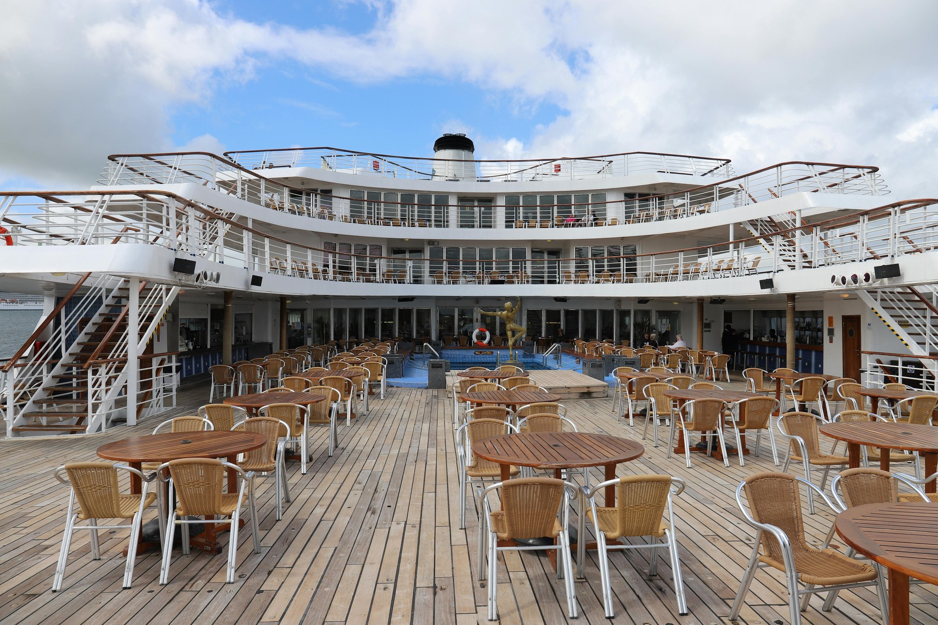 The upper deck of a Nile cruise boat with loungers looking out over the river